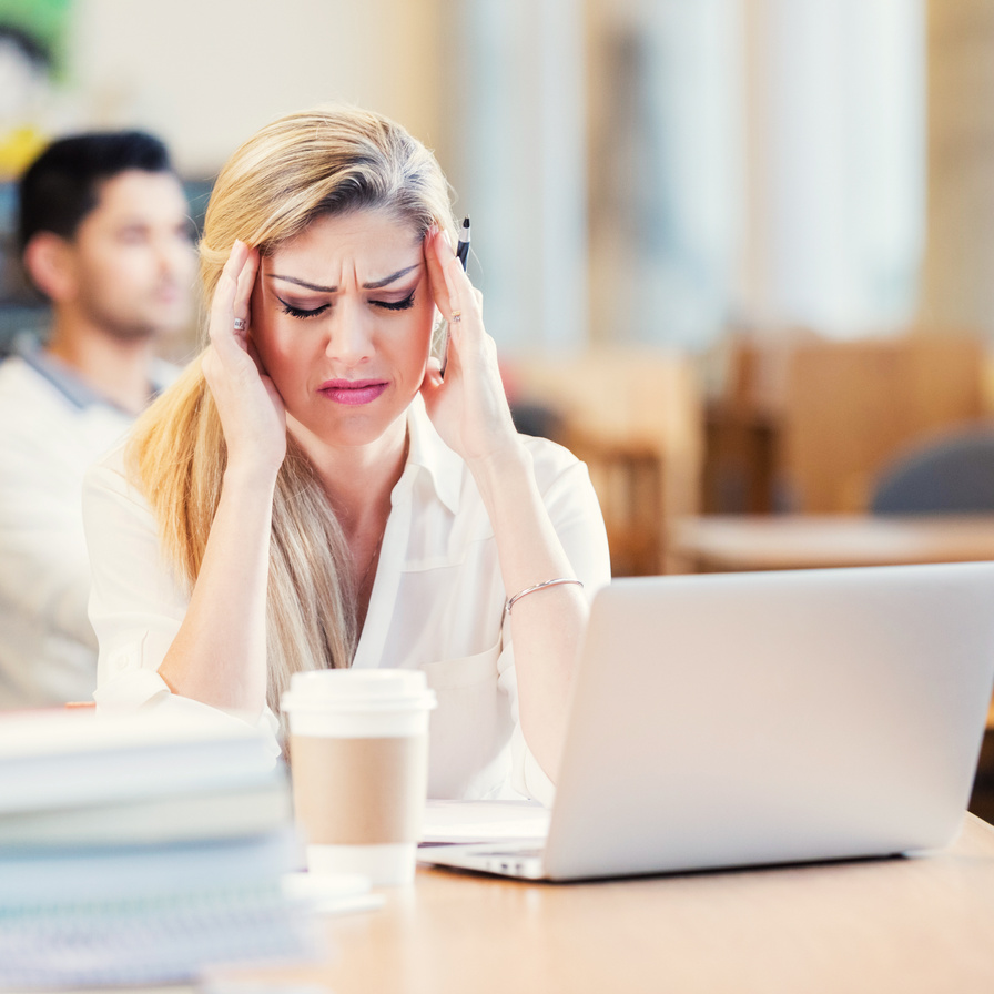 Frustrated college student studying in library